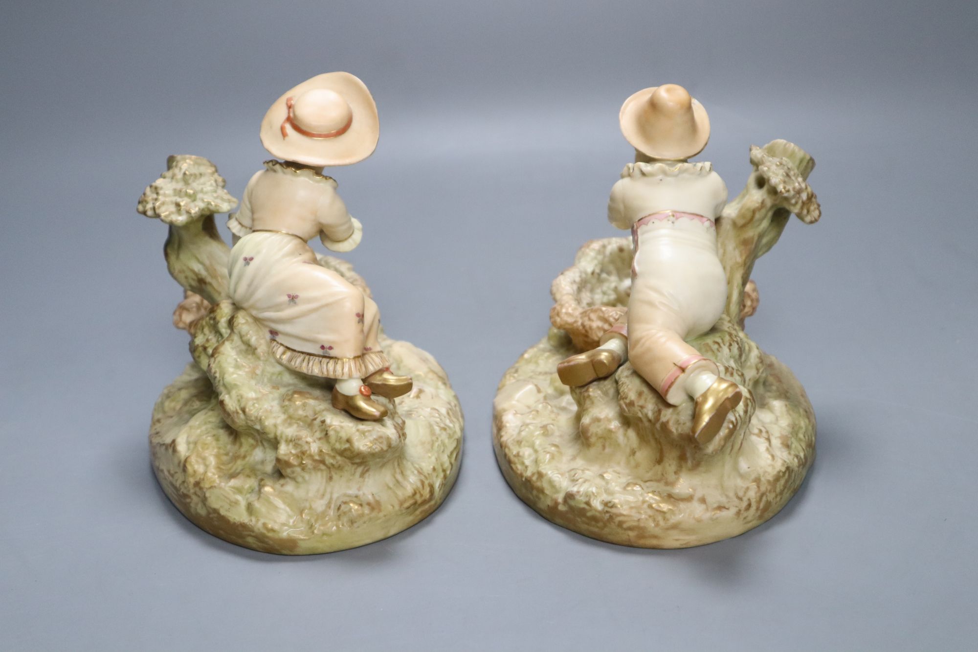 A pair of Worcester James Hadley blush ivory figural dishes, height 15cm